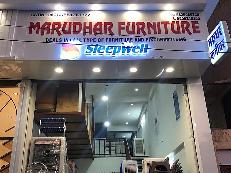 Marudhar Furniture storefront at night with lit Sleepwell sign